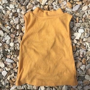 Yellow mock-neck crop top .